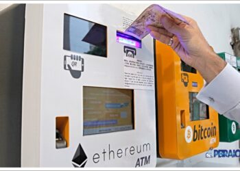A man uses the Ethereum ATM in Hong Kong, Friday, May 11, 2018. Ethereum is one of the world's popular virtual currency. (AP Photo/Kin Cheung)