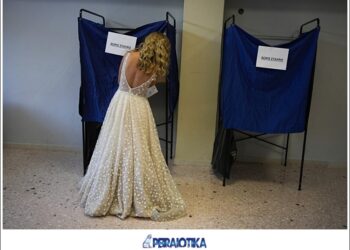 A woman, wearing her just married wedding dress, votes at a polling station in Athens, Greece, Sunday, June 25, 2023. Polls have opened in Greece for the second general election in less than two months, with the conservative party a strong favorite to win with a wide majority. (AP Photo/Thanassis Stavrakis)